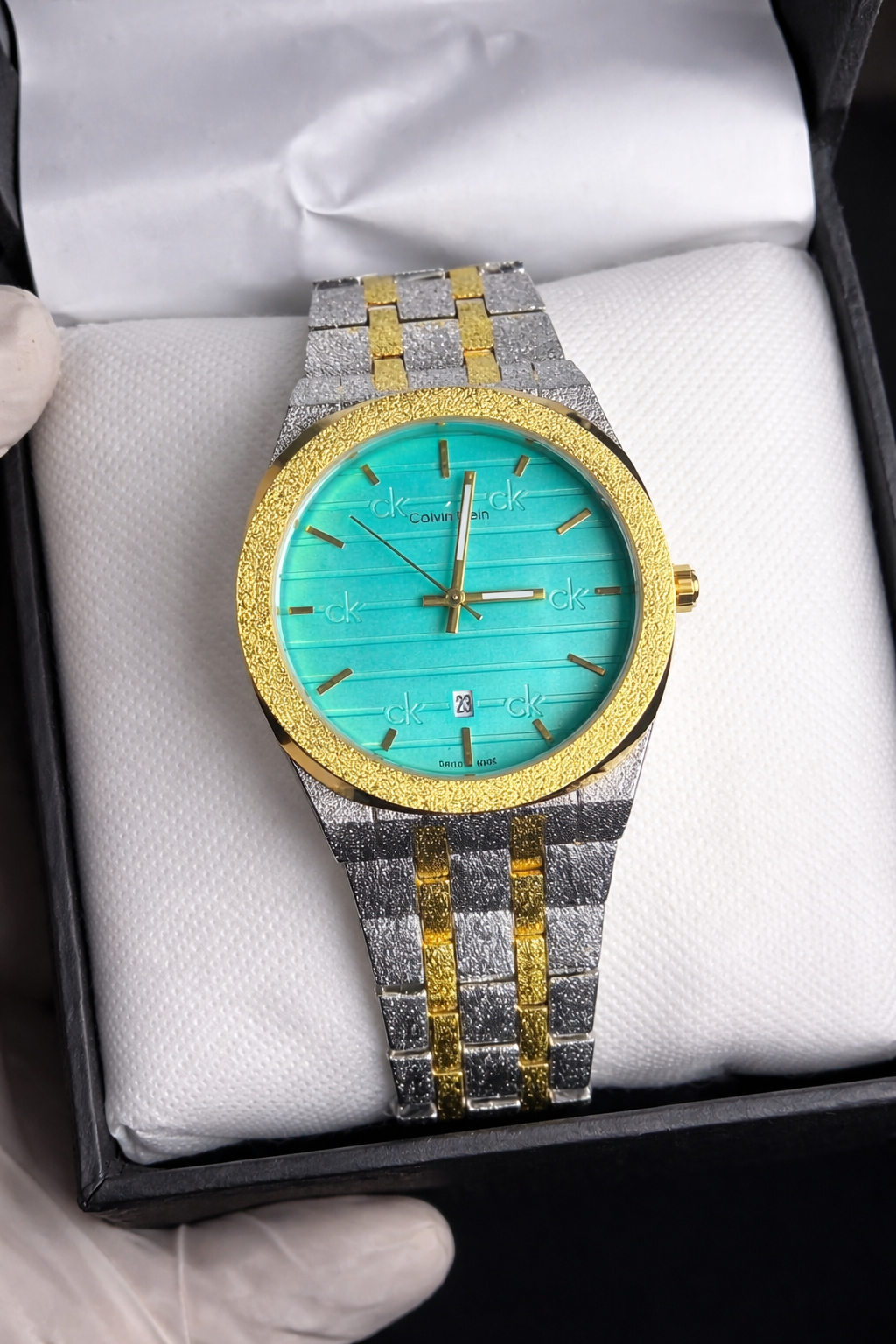 Luxury watch with turquoise face and gold accents