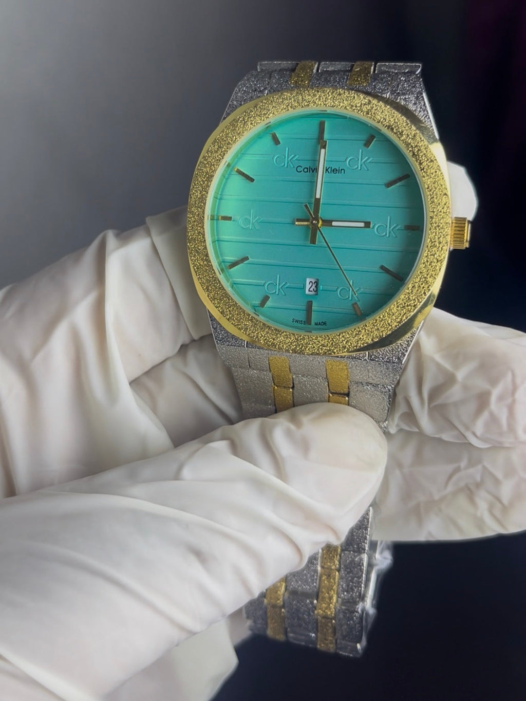 Luxury watch with turquoise face and gold accents