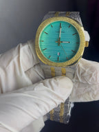 Luxury watch with turquoise face and gold accents