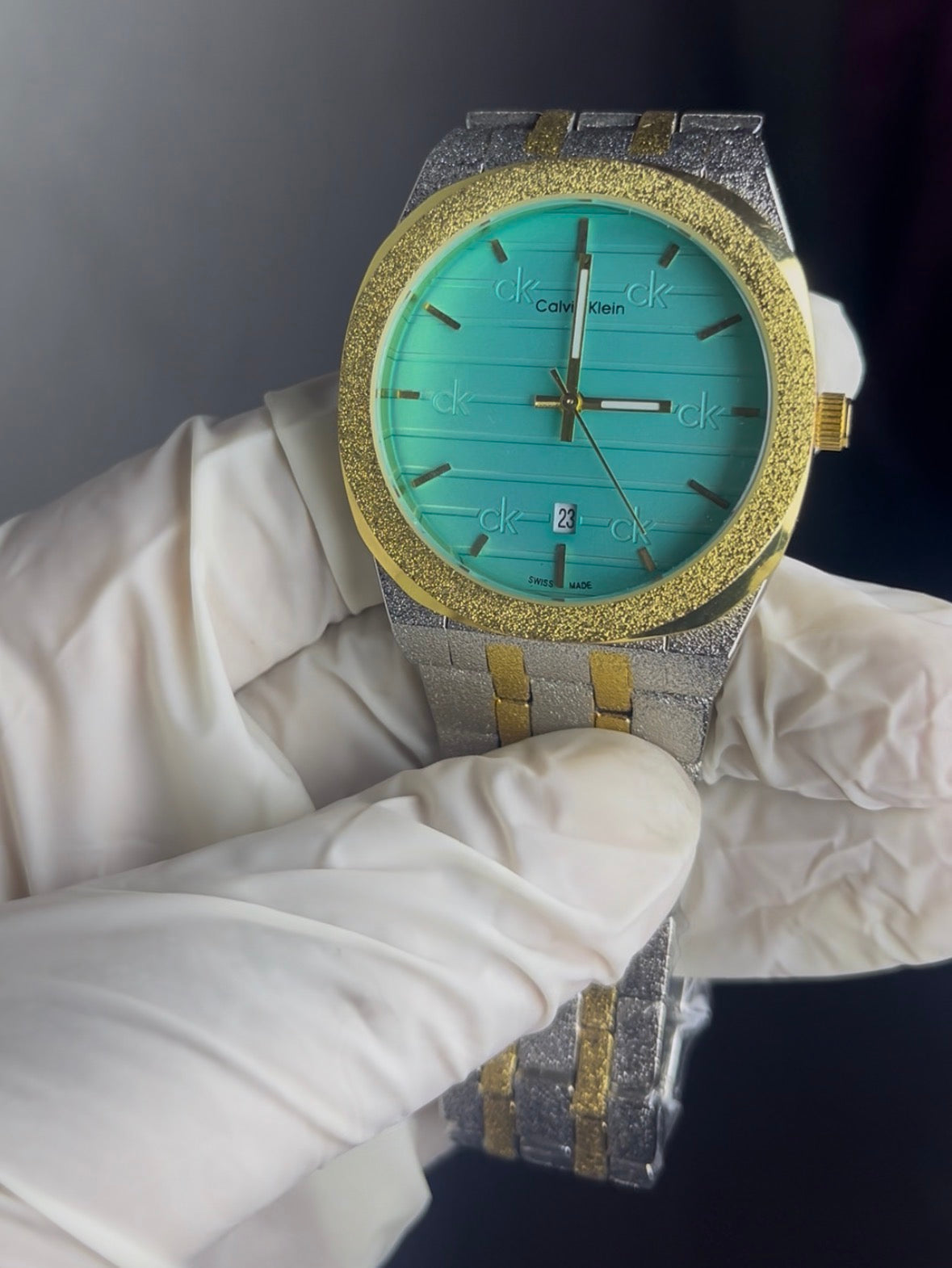 Luxury watch with turquoise face and gold accents