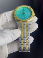 Luxury watch with turquoise face and gold accents